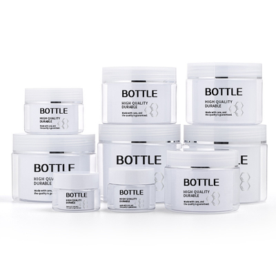 I barattoli della parete affrontano il cosmetico del barattolo della crema della plastica di trucco delle lozioni di cura di pelle dei capelli della mano
